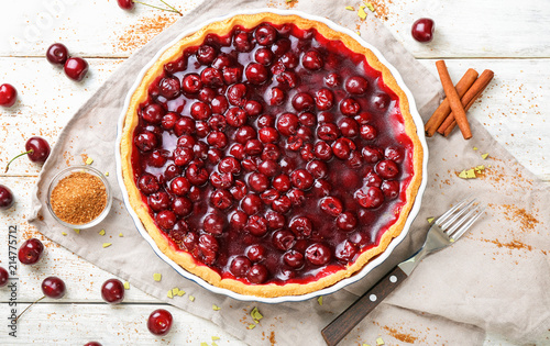Tasty homemade cherry pie on white wooden table