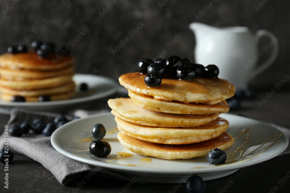 Plate with delicious pancakes and berries on table Plate with delicious pancakes and berries on table