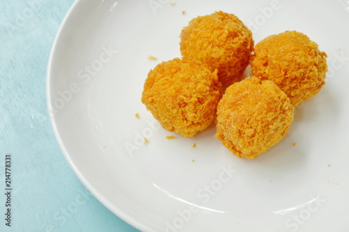 fried cheese ball on white plate