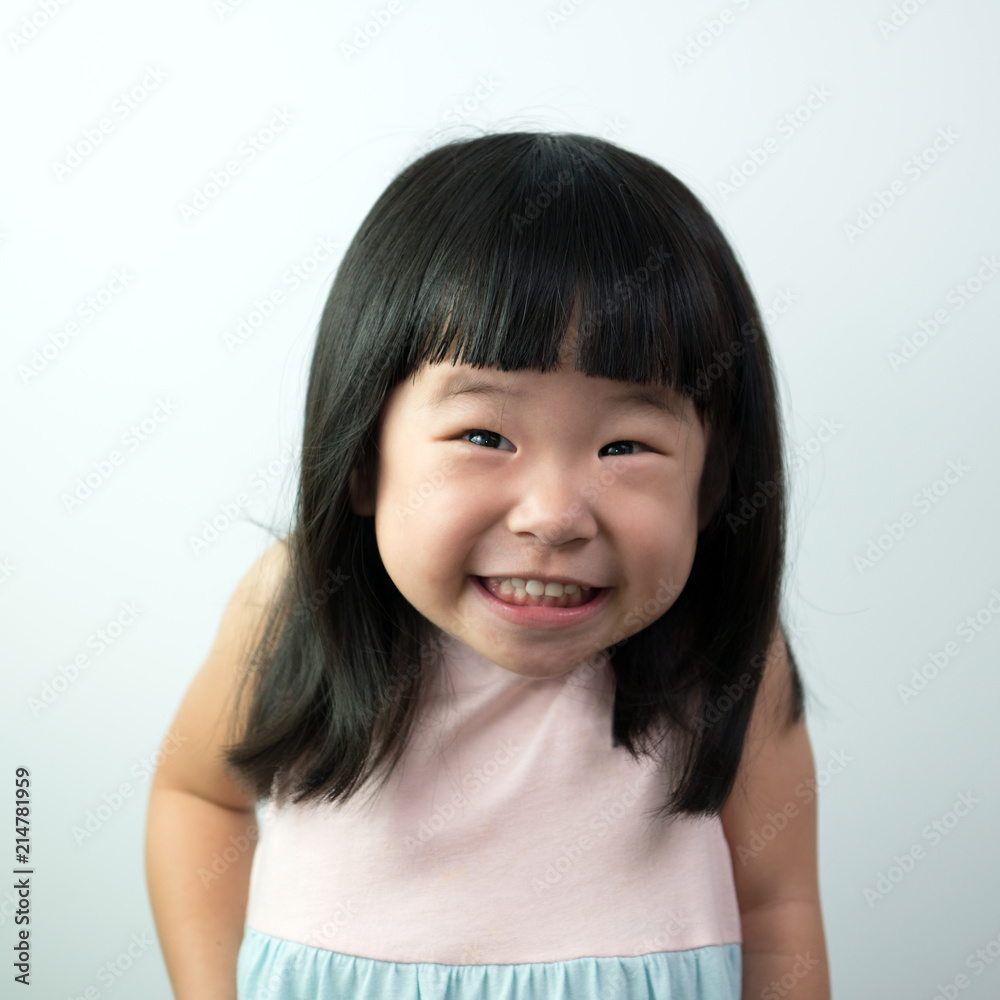 Happy little asian girl with funny face isolated on white background Stock  Photo | Adobe Stock