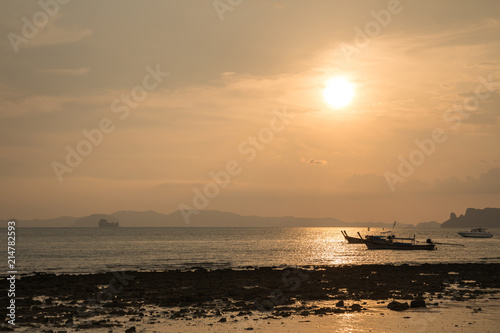 beautiful beach and boat in Krabi Thailand with sunrise