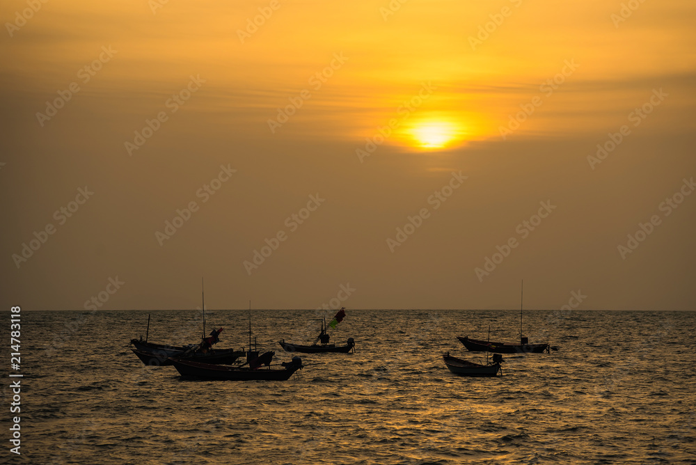 Floating fishing boats aground at the harbor in the sea sunset time at Chanthaburi, Thailand.