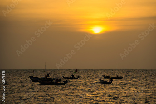 Floating fishing boats aground at the harbor in the sea sunset time at Chanthaburi, Thailand. © bubbers