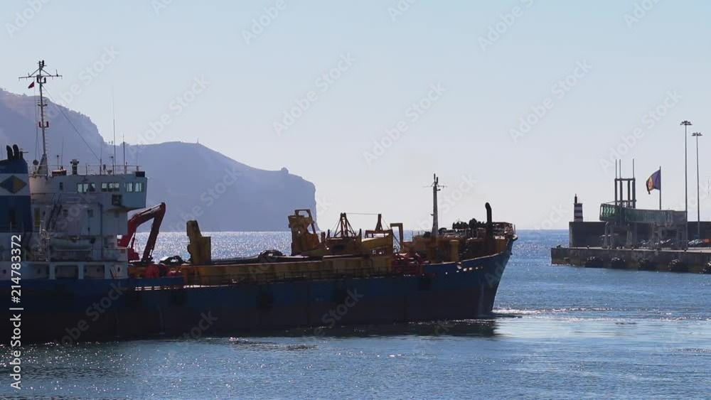 Cargo ship leaving harbour in portugal Cargo ship leaving harbour in portugal