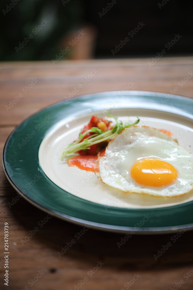 Zucchini fritters with egg and smoked salmon on wood background vinage style Zucchini fritters with egg and smoked salmon on wood background vinage style