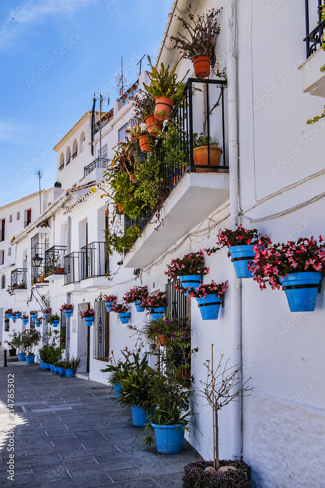 Fototapeta premium Beautiful view of old Mijas Calle Moro (Moro Street). Mijas (not far from Malaga) - Spanish hill town overlooking the Costa del Sol, known for its white-washed buildings. Mijas, Andalusia, Spain.