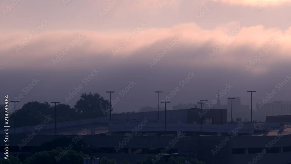 A time lapse of the sun rising over a parking garage A time lapse of the sun rising over a parking garage