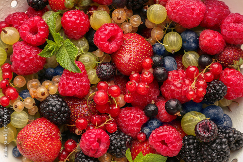 Colander with fresh ripe berries, closeup