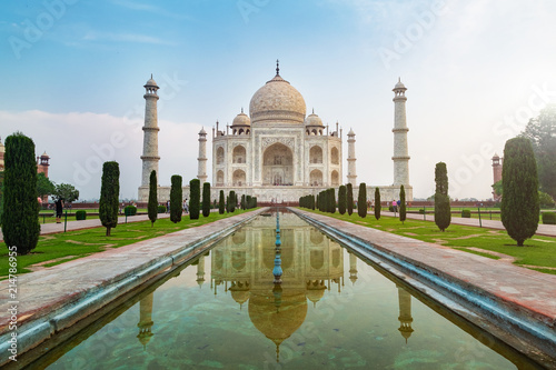 Taj Mahal front view reflected on the reflection pool, an ivory-white marble mausoleum on the south bank of the Yamuna river in Agra, Uttar Pradesh, India. One of the seven wonders of the world.