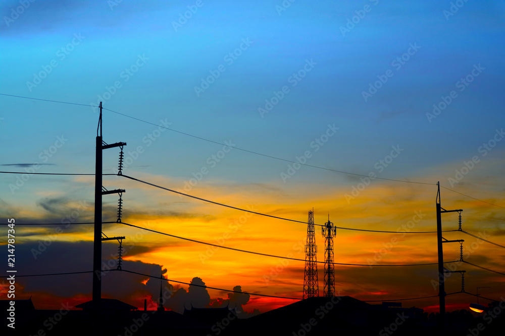 Fototapeta premium silhouette of power electric line pillar and colorful sunset