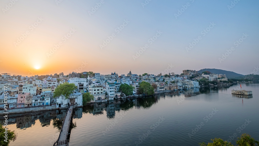 Udaipur city at lake Pichola in the morning, Rajasthan, India. View of City palace reflected on the lake.