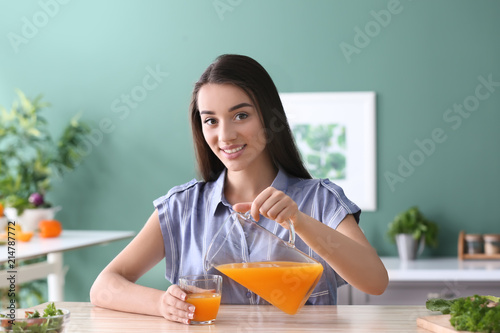 Young woman pouring citrus ...