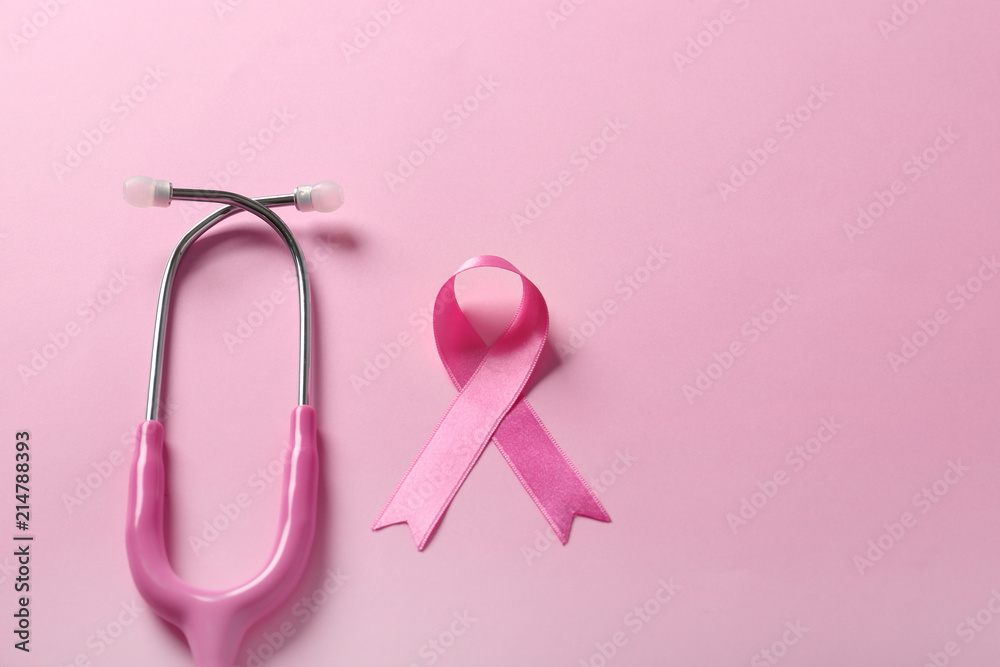 Pink ribbon and stethoscope on color background. Breast cancer awareness concept Pink ribbon and stethoscope on color background. Breast cancer awareness concept