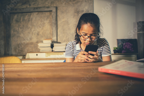 asian teenager reading message in smart phone photo