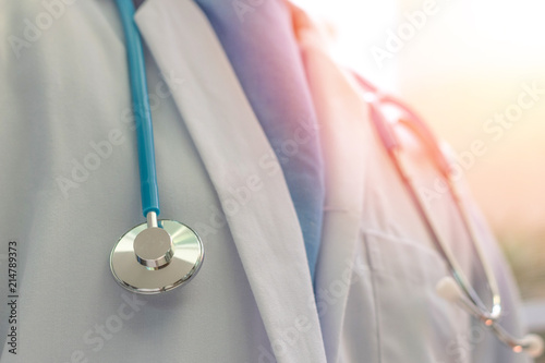 Medical doctor or physician in white gown uniform with stethoscope in hospital or clinic photo