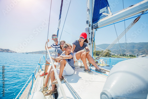 Family with adorable kids resting on yacht © Max Topchii
