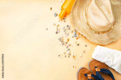 Top view of flip flops, straw hat and white towel photo