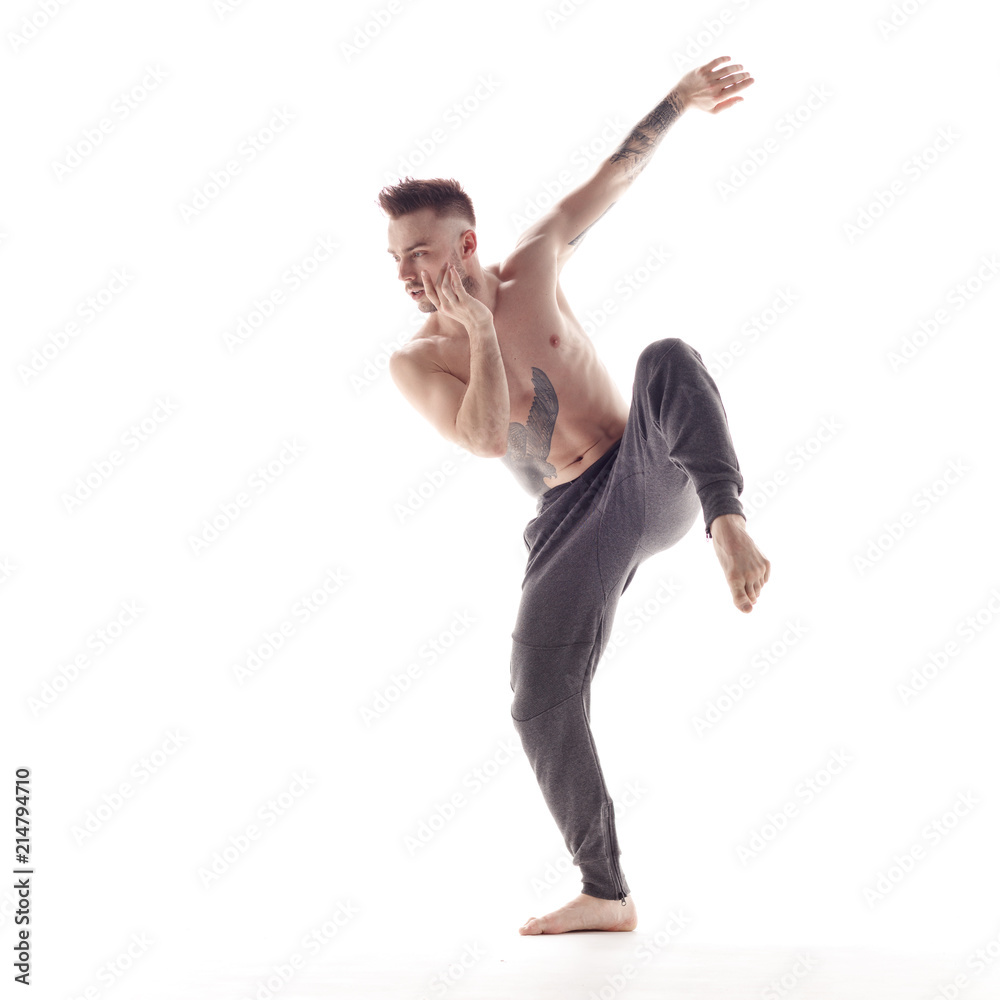 Obraz premium Young beautiful dancer is posing in studio