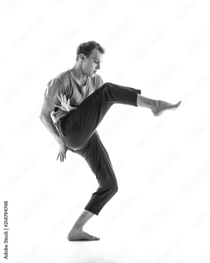 Young beautiful dancer is posing in studio