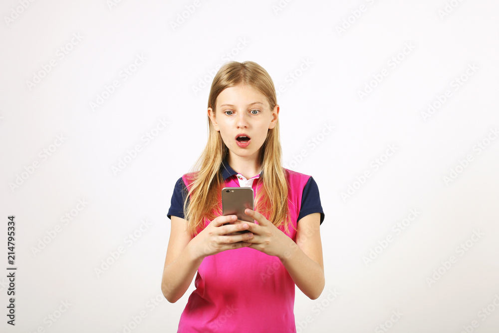 Young amazed woman wearing pink blue baseball shirt receiving surprising text message on cell phone with open mouth. Astonished blonde teenage female with smartphone. Copy space background, portrait Young amazed woman wearing pink blue baseball shirt receiving surprising text message on cell phone with open mouth. Astonished blonde teenage female with smartphone. Copy space background, portrait
