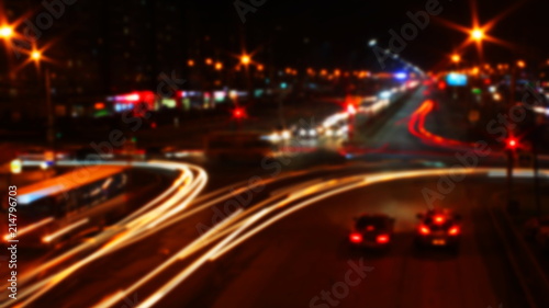 blurred traffic light trails on road at night in Russia