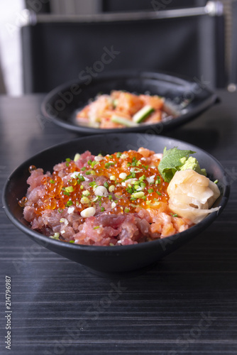 Premium fresh raw seafood mixed rice bowl (Kaisen-don/ Japanese tasty food), Japanese Rice with sashimi of tuna, Maguro, Otoro, salmon and ikura (Salmon eggs) on wood background