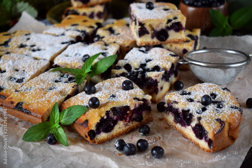 Finnish bilberry pie cut into square pieces sprinkled with sugar powder