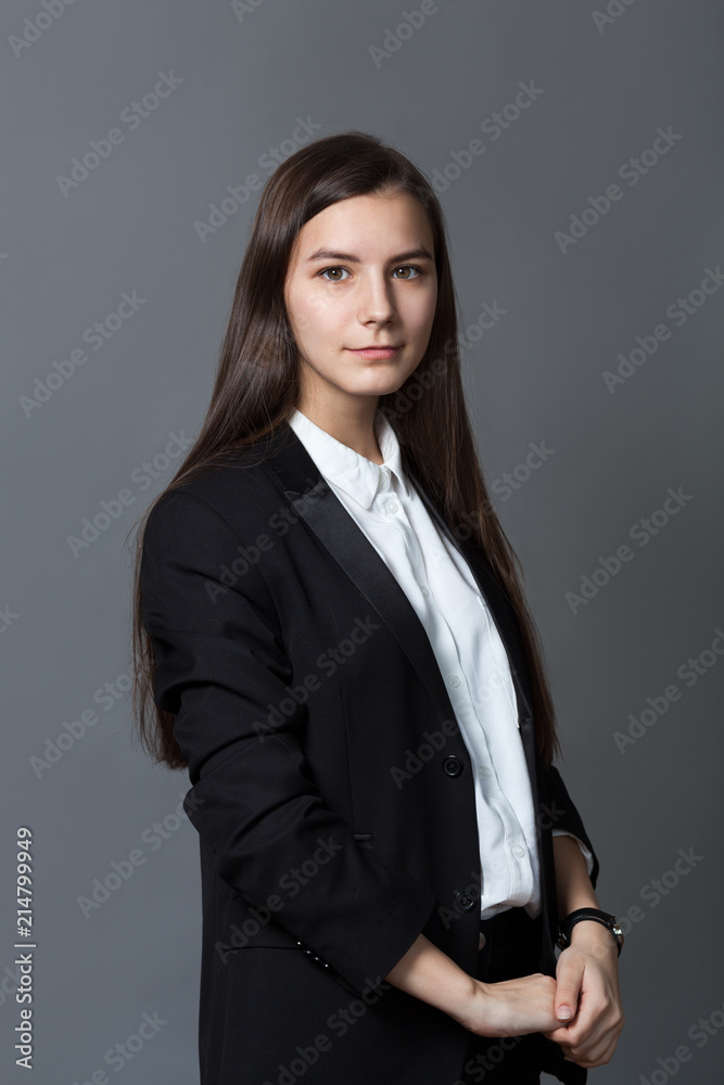 Portrait of happy nice schoolgirl teenager in white shirt on gray background Portrait of happy nice schoolgirl teenager in white shirt on gray background