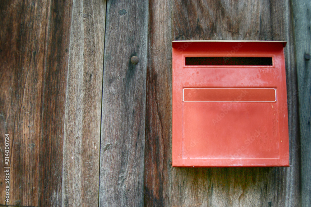 Red mailbox with wood wall, red letter box with wood wall