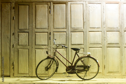 park bicycle in front of wood house
