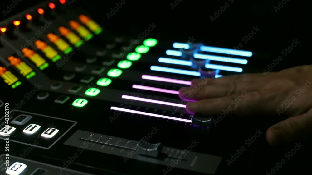 The director on light works behind the control panel. Close-up of a remote control light on a stage with lots of buttons and levers. The director on light works behind the control panel. Close-up of a remote control light on a stage with lots of buttons and levers.