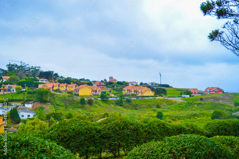 View of Guell y Martos park, with houses at the background, in Comillas, Cantabria, Spain