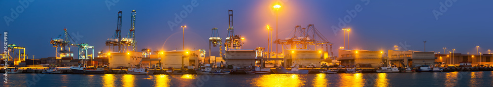 Evening view of   cranes and containers in seaport