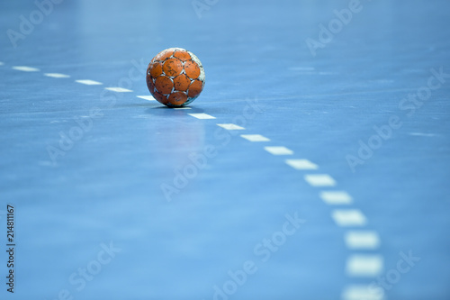 handball ball laying on the 9 meters dotted line on the pitch