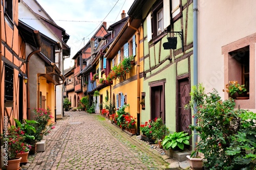 Colorful street in the of the town of Eguisheim, Alsace, France with timbered houses
