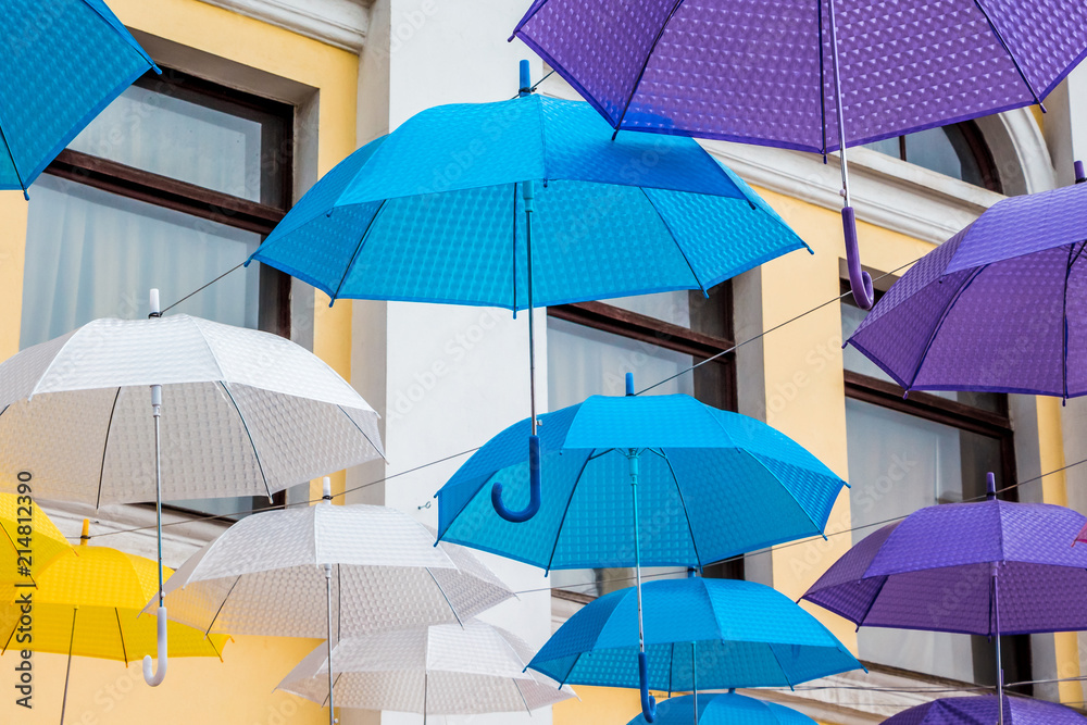 Multi-colored umbrellas adorn the city's street during the holiday, close-up_