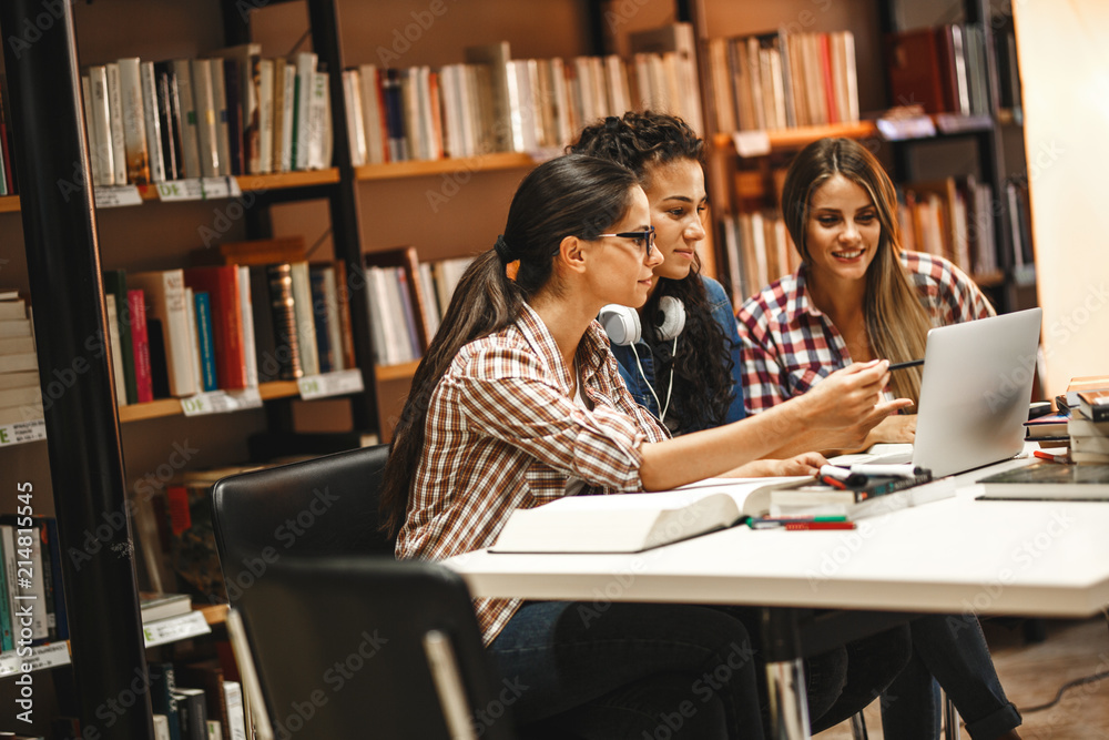Group of female students study in the school library.Learning and preparing for university exam.Education concept. Group of female students study in the school library.Learning and preparing for university exam.Education concept.