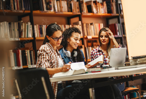 Group of female students study in the school library.Learning and preparing for university exam.Education concept.