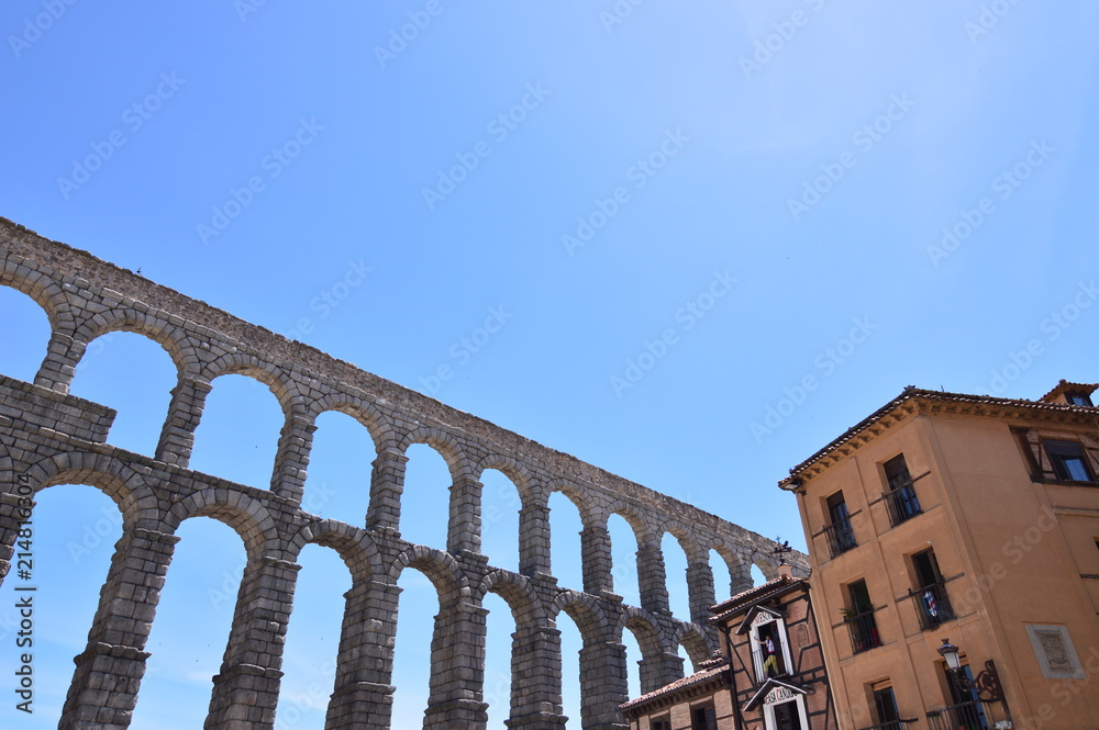 Oblique Photo Of The Aqueduct With Person Making A Photo From A Balcony Of A Nearby Bar In Segovia. Architecture, Travel, History. June 18, 2018. Segovia Castilla Leon Spain.
