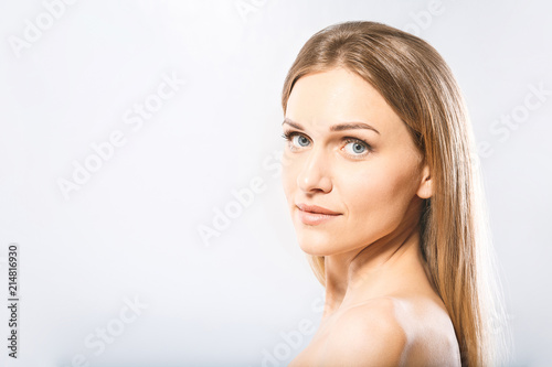 Beauty Woman face Portrait. Beautiful Spa model Girl with Perfect Fresh Clean Skin. Blonde female looking at camera and smiling. Youth and Skin Care Concept