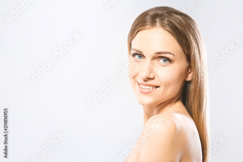 Beauty Woman face Portrait. Beautiful Spa model Girl with Perfect Fresh Clean Skin. Blonde female looking at camera and smiling. Youth and Skin Care Concept