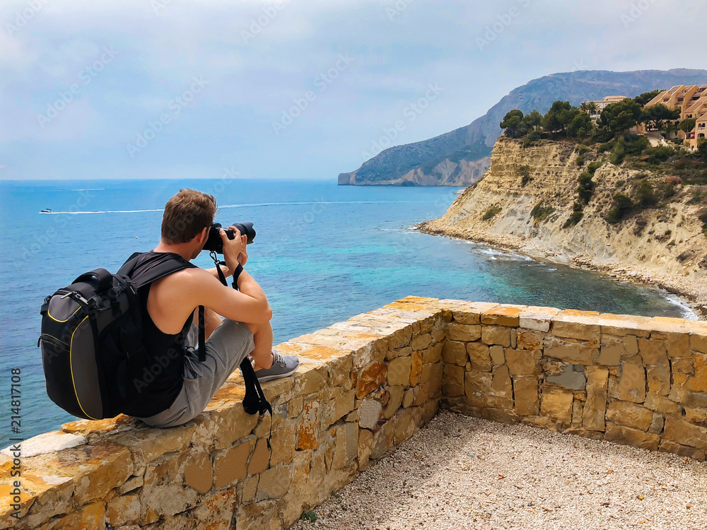 Photographer taking a picture of a ocean coast
