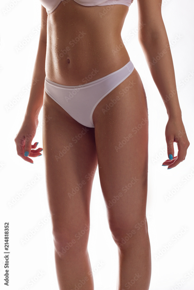The woman shows a beautiful body. White underwear. An elastic body with good muscles. Sports body. Sport, health, diets.