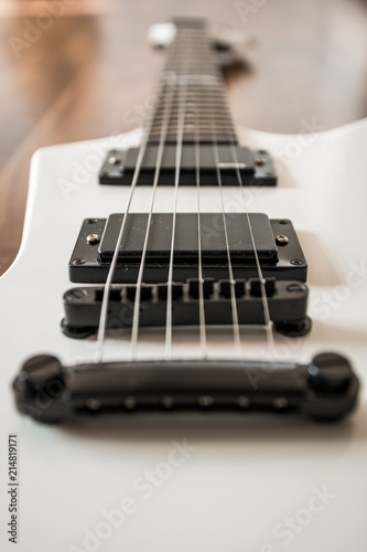 Weiße Heavy E-Gitarre auf braunem Hintergrund