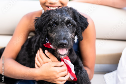 Girl holding Australian shepherd puppy photo