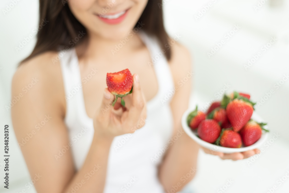 Happy Young woman smiling holding strawberries. Happy Young woman smiling holding strawberries.