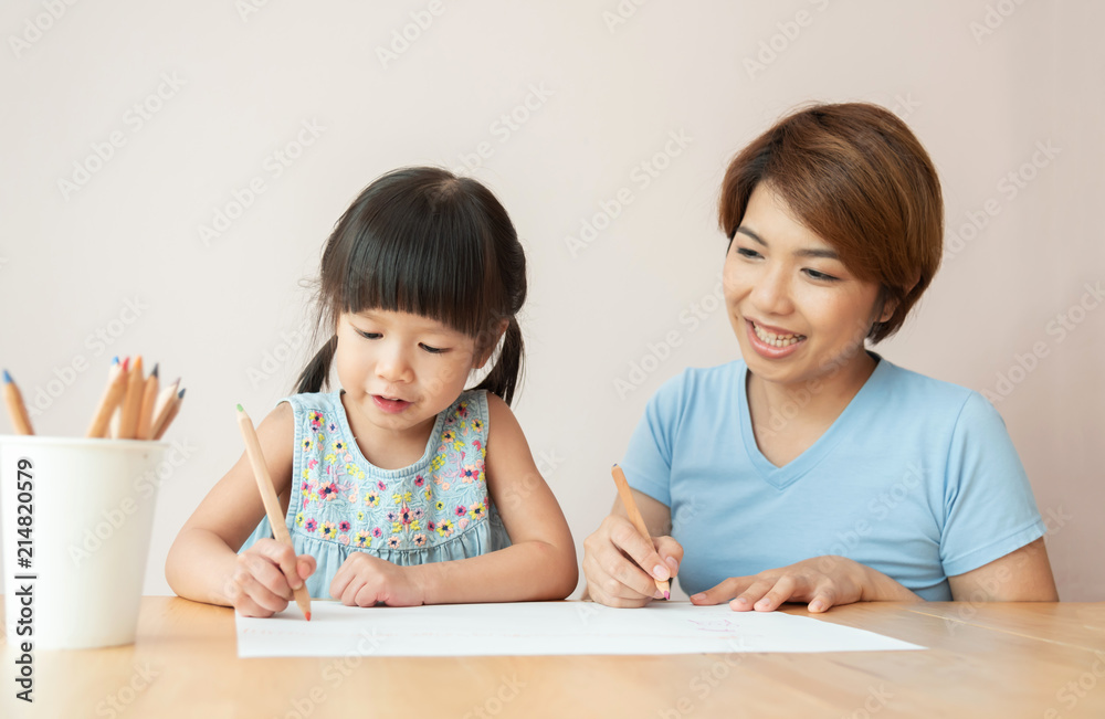 Happy Asian Mother and daughter drawing together. Happy Asian Mother and daughter drawing together.