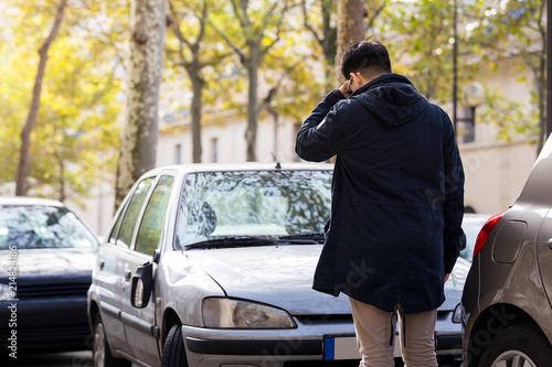serious man stand in fron of his broken car in autumn at Paris, © kunchainub