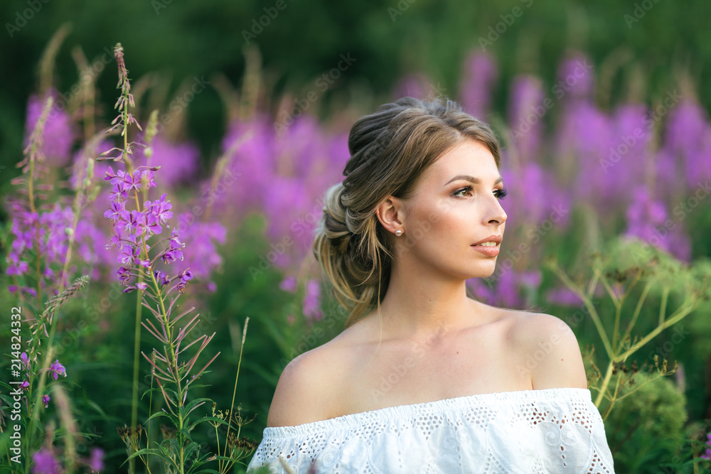 Beautiful young happy girl in the blossoming fields, thinking about her life and goals. Slow life, minimalism, mindfulness Beautiful young happy girl in the blossoming fields, thinking about her life and goals. Slow life, minimalism, mindfulness
