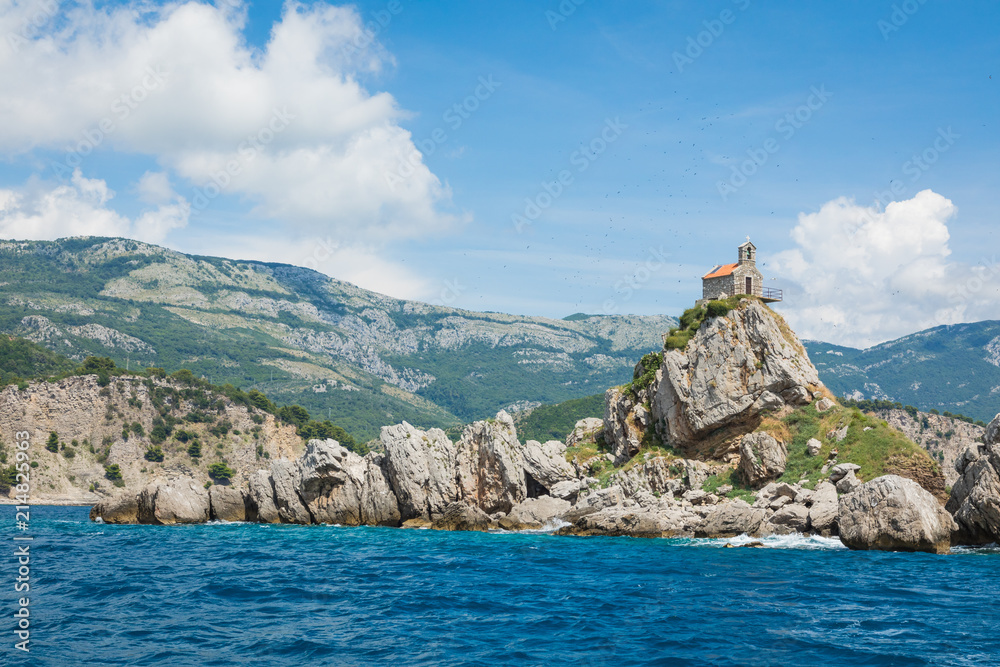 View of beautiful islets Katic (Katich) and Sveta Nedjelja with church on one of them in the sea near Petrovac, Montenegro. View of beautiful islets Katic (Katich) and Sveta Nedjelja with church on one of them in the sea near Petrovac, Montenegro.